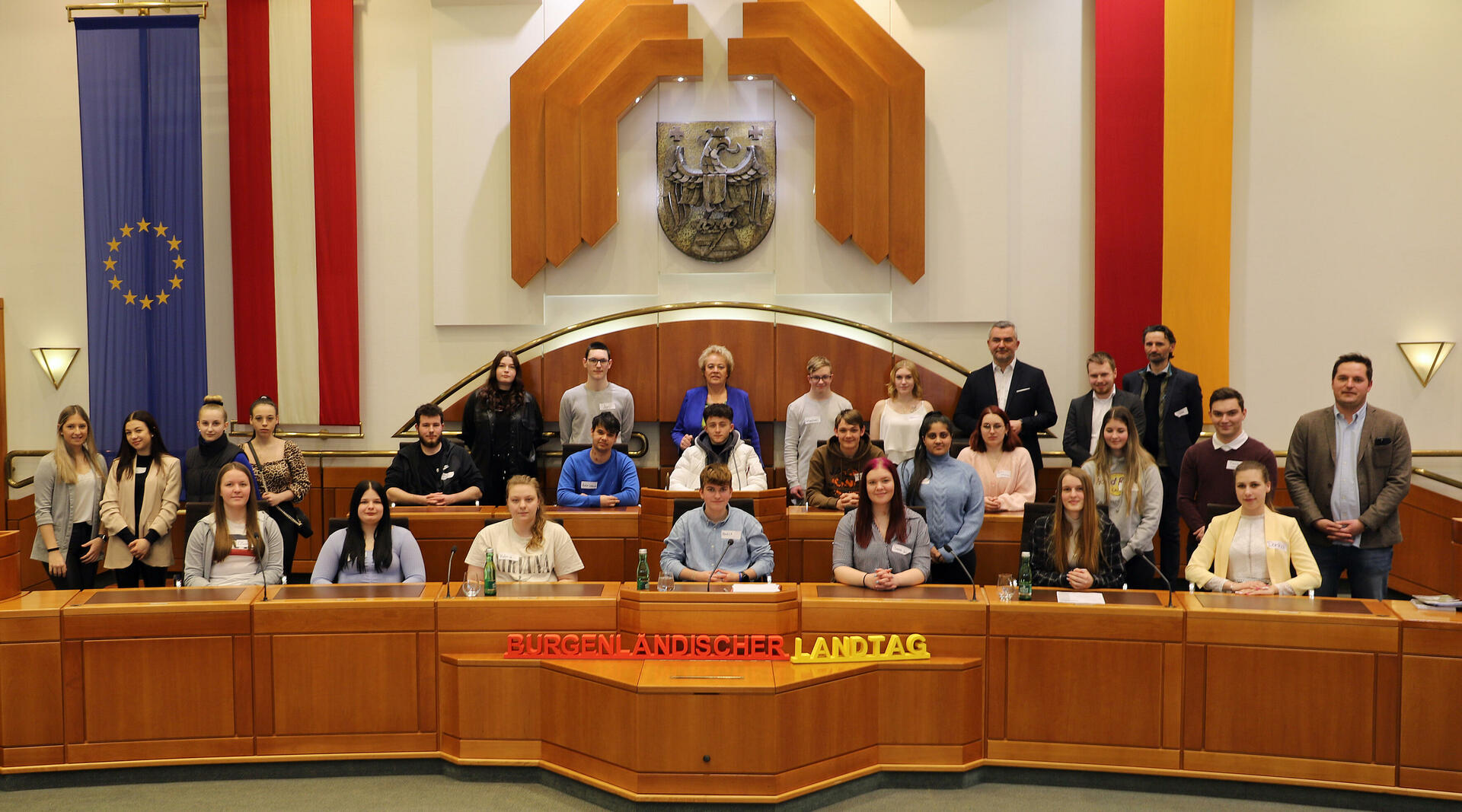 Landesrat Mag. Heinrich Dorner (5.v.r. stehend, hinten) mit Landtagspräsidentin Verena Dunst (Mitte, hinten) sowie Direktor Karl Kruisz, MA Bed (rechts, stehend) und Professor Günther Fädler (3.v.r., stehend) und Auslandsdiener Jonathan Dorner (4.v.r., stehend) sowie den Schülerinnen und Schülern der 3. Klasse der Berufsschule Eisenstadt.